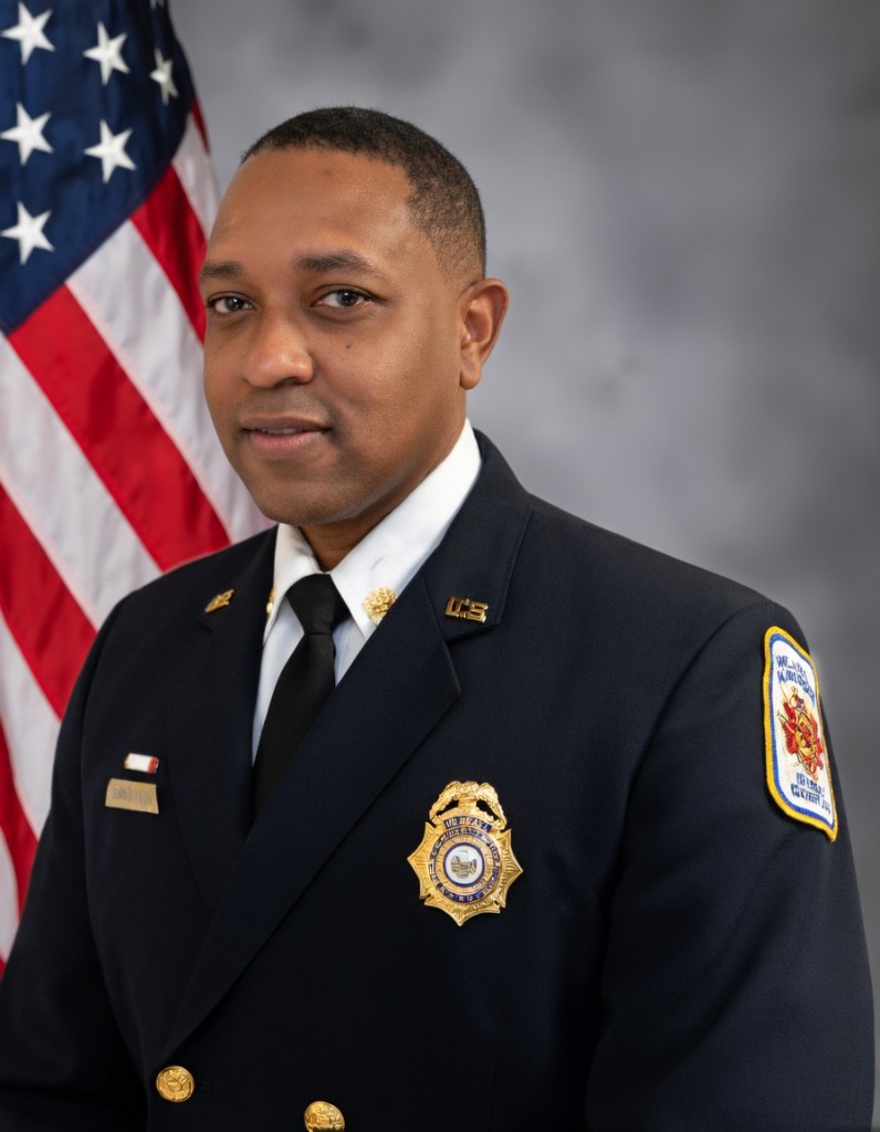 Reginald Wadley, professional portrait in formal uniform with American flag in the background